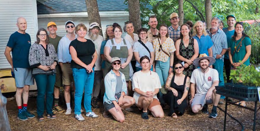Volunteers and garden hosts gathered in a garden