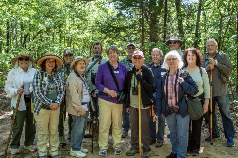 A group of members on a wooded trail